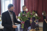Dyrektorzy (Andrzej Mazuś, Krzysztof Dąbek, Alina Tkaczyk trzymają w dłonach kwiaty w auli szkolnej. Kliknięcie w miniaturkę obrazka spowoduje wyświetlenie powiększonego zdjęcia.